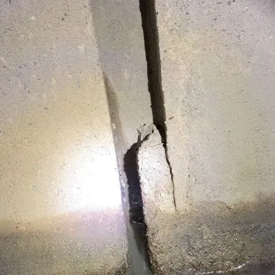 Grout in a pipe joint that has partially fallen out of place