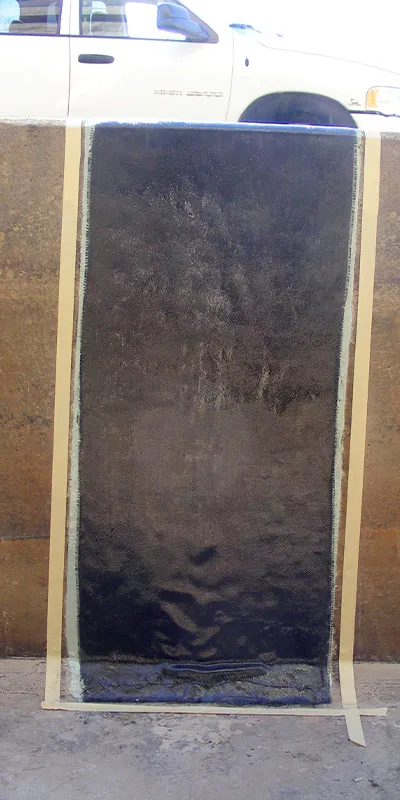 A crack running through a cooling tower basin's wall that has been restored with HydraWrap