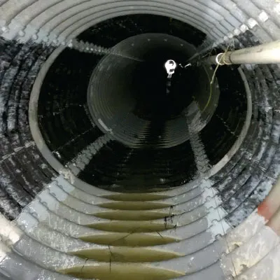 Inside a corrugated metal pipe that has been coated in epoxy and a portion of it has been reinforced with the carbon fiber fabric, HydraWrap