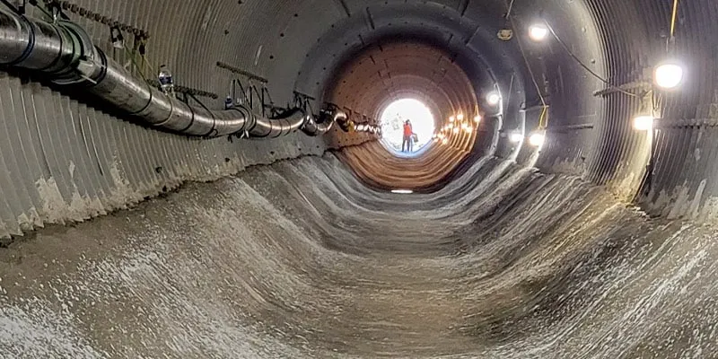 A long corrugated metal pipe with the invert paved in concrete