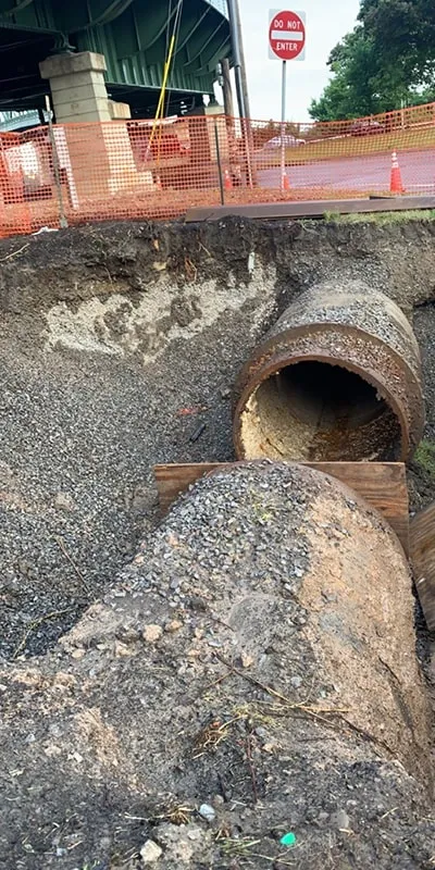 A pipe that has been dug down to and opened to allow for access