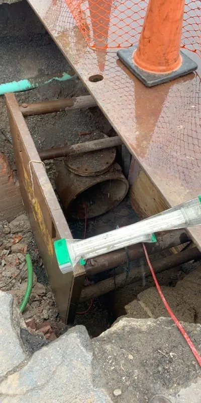 A pipe that has been dug down to and opened to allow for access