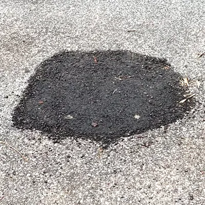 A small concrete patch in a road