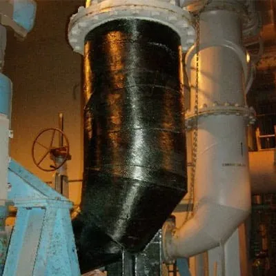 A reducing elbow pipe at a waste water facility wrapped in HydraWrap