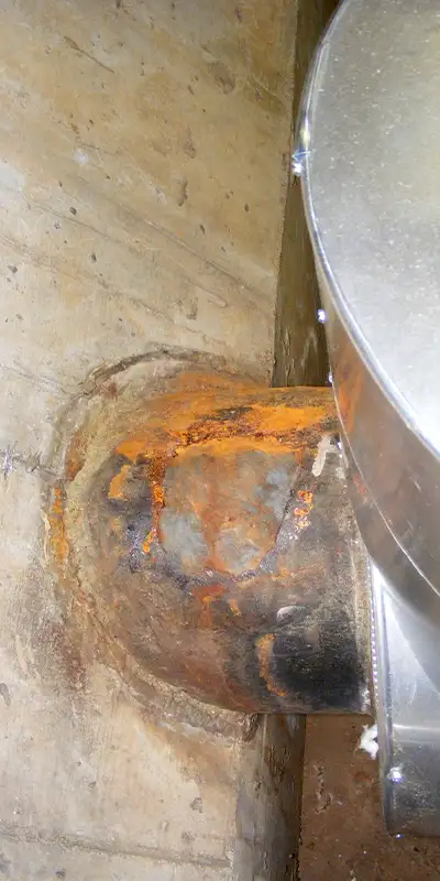 A corroded portion of a cast iron pipe