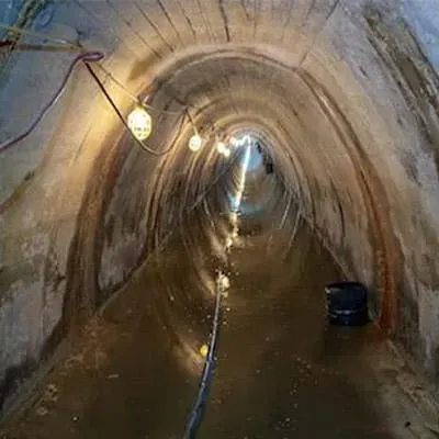 A line of lights used to illuminate an irregularly-shaped tunnel