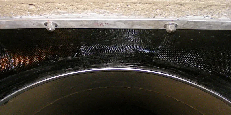 Irregular joint between a pipe and tunnel that has been restored with HydraWrap