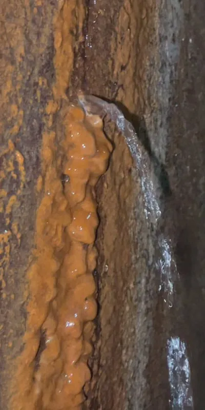 A very active leak letting water enter the pipe