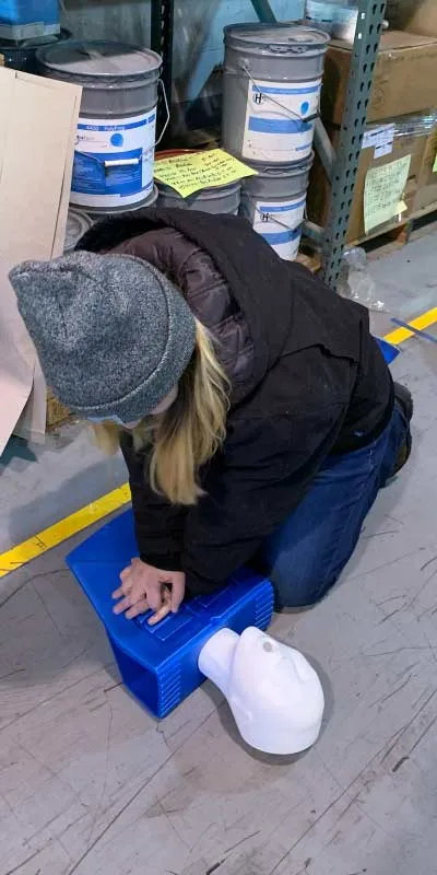 A technician practicing CPR on a dummy