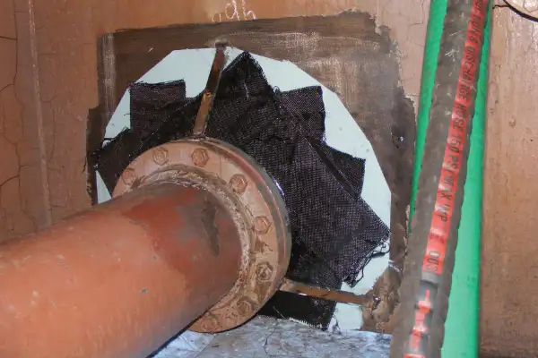 Bulkhead penetration point that has been reinforced with HydraWrap, the structurally composite repair system
