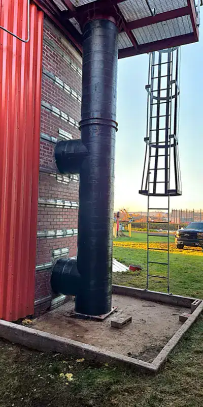 HydraWrap applied to a vertical digester mixing pipe to fortifying it against corrosion