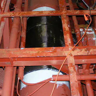 A large tee fitting in a water cooling system that has been restored with HydraWrap