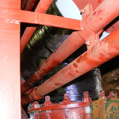A large tee fitting in a water cooling system that has been restored with HydraWrap