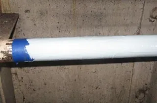 A portion of a condensate pipe onboard a vessel that has been coated in epoxy