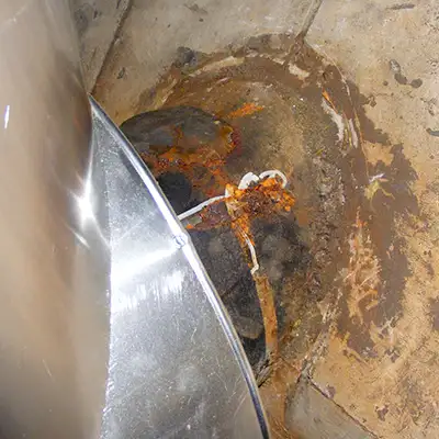 A corroded portion of a cast iron pipe