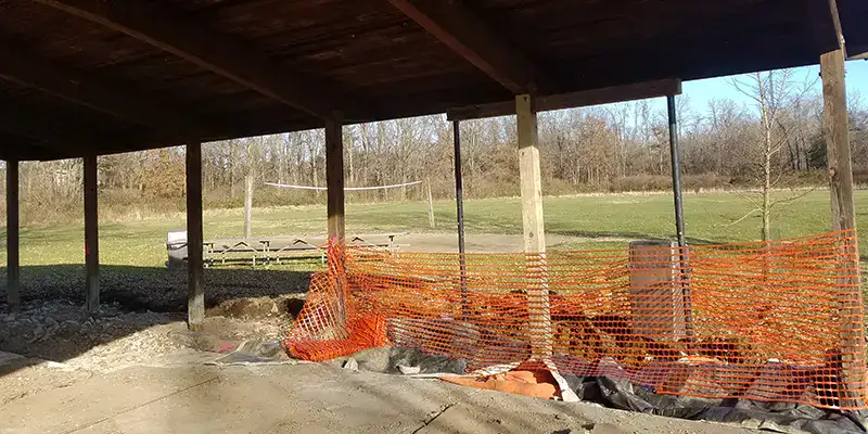 A row of pavilion posts that have degraded with age