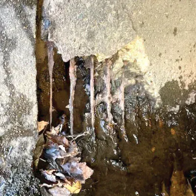 Spalling concrete near a joint in a pipe