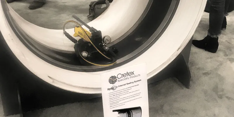 A demo pipe at a trade show with a HydraTite seal and expander inside it