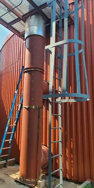 An old vertical digester mixing pipe suffering from corrosion