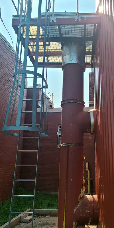 An old vertical digester mixing pipe suffering from corrosion