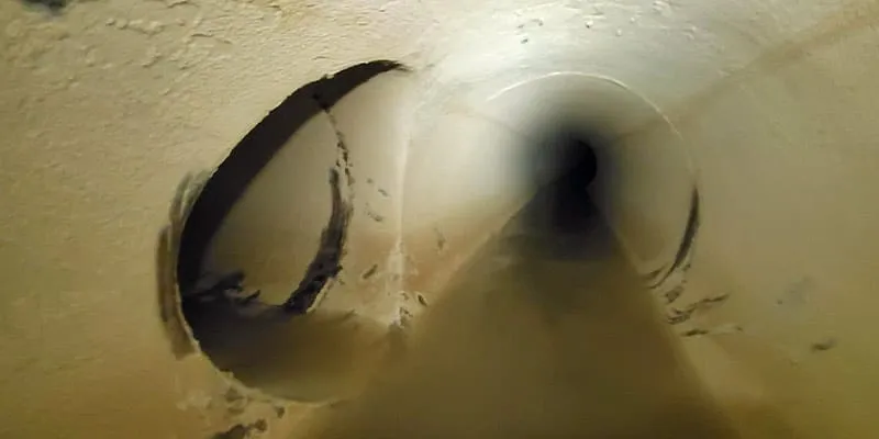 A long dark pipe with an offshoot to the left