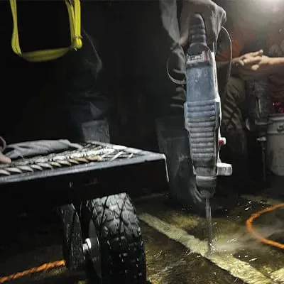 A box-culvert wall being drilled so that anchors can be inserted