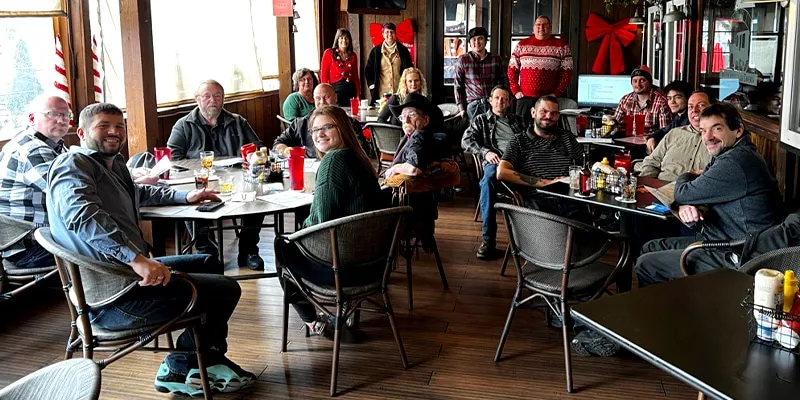 Several employees sitting at the Christmas lunch