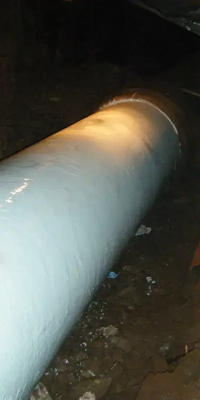 A portion of a cast iron pipe that has been coated in epoxy