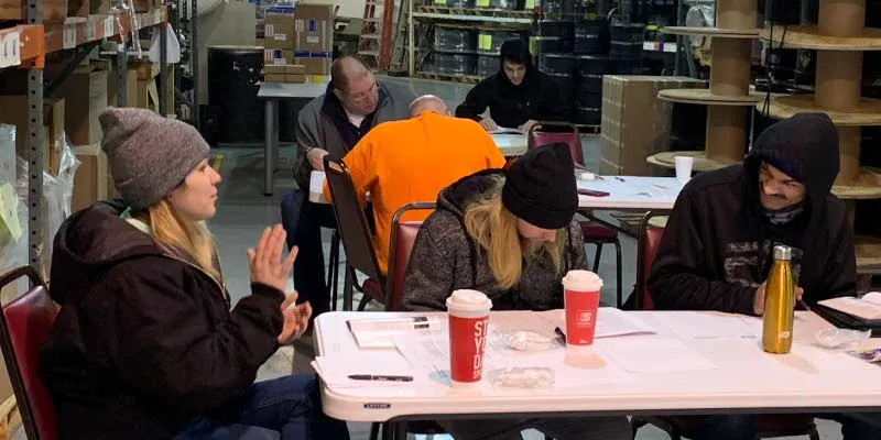 Field Service members sitting at a table learning safety and emergency responses