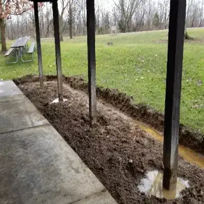 A row of wooden columns that have deteriorated near the base