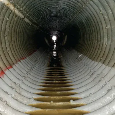 HydraLine coating the invert of a corrugated metal pipe