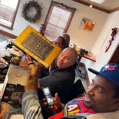 Employees opening gifts at a company Christmas party