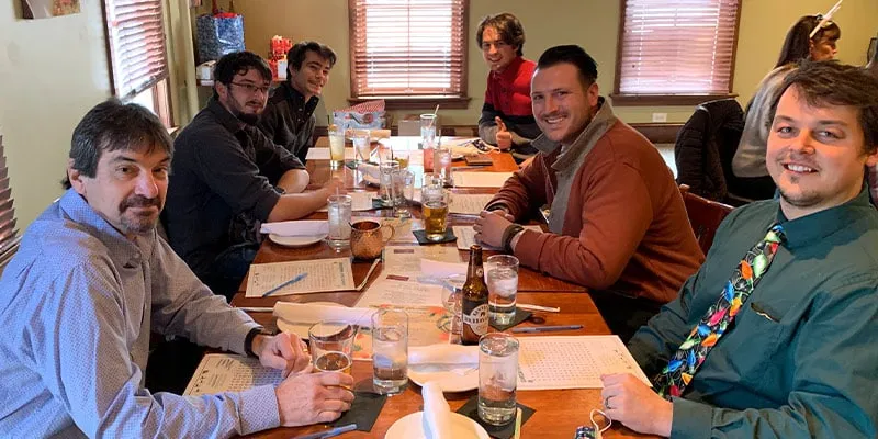 A group of HydraTech employees sitting together for the yearly Christmas lunch