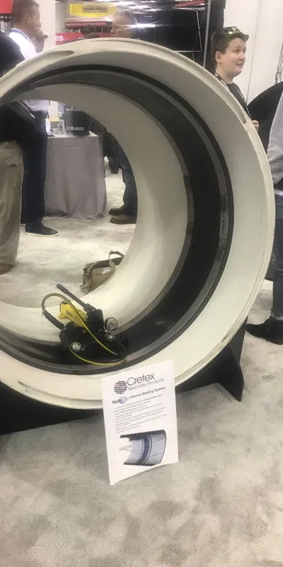 A demo pipe at a trade show with a HydraTite seal and expander inside it