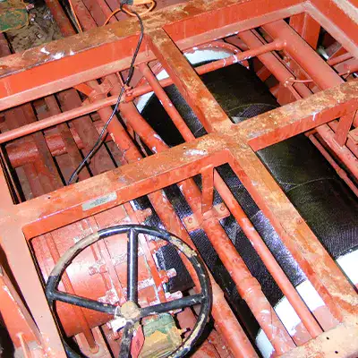 A large tee fitting in a water cooling system that has been restored with HydraWrap