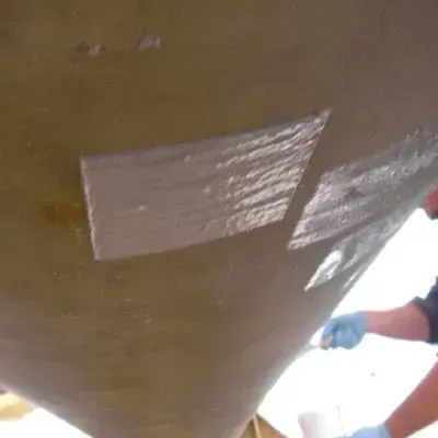 Two patches applied to address two pinhole leaks in a surge vessel at a natural gas facility