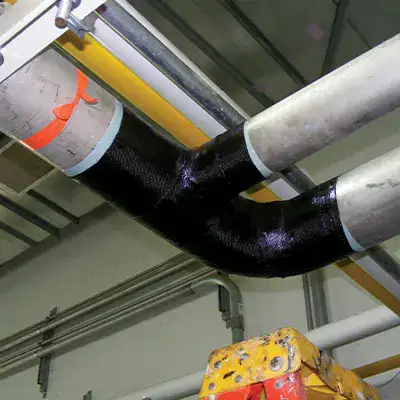 A tee and elbow pipe wrapped with HydraWrap, restoring this segment of pipe