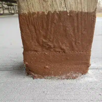 A wooden post that has been wrapped in HydraWrap