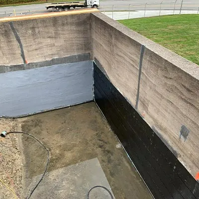 The concrete walls of a hydraulic jumps at a water treatment facility. The walls have been reinforced with HydraWrap