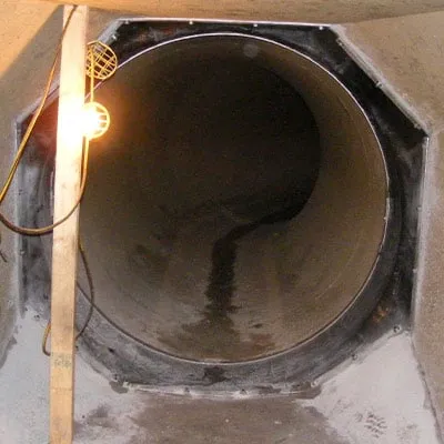 Irregular joint between a pipe and tunnel that has been restored with HydraWrap