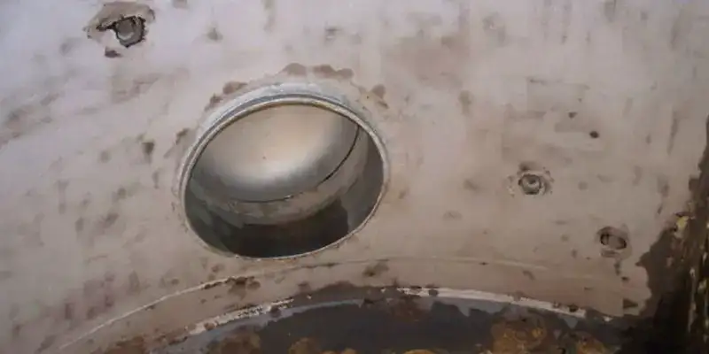 Inside view of a condenser water box that has become corroded