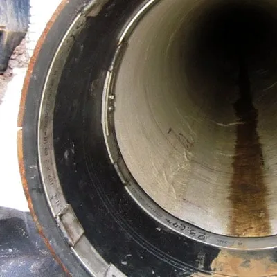 HydraTite installed at the end of a pipe locking down a liner