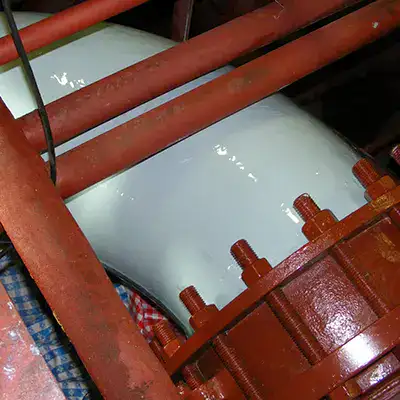 A portion of a cooling water supply pipe coated in an epoxy
