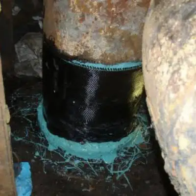 A portion of a heavy fuel oil line that has been wrapped in carbon fiber fabric, HydraWrap