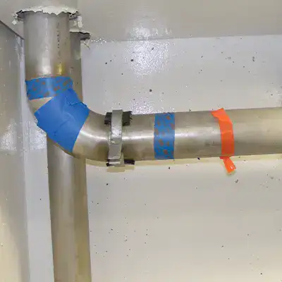 A portion of pipe taped off for repair