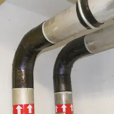 Two elbow pipes wrapped in the carbon fiber fabric of HydraWrap to restore them to service