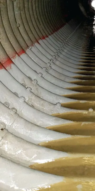 A corrugated pipe with the invert coated in epoxy
