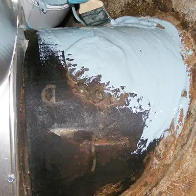 A portion of a cast-iron pipe being coated in epoxy