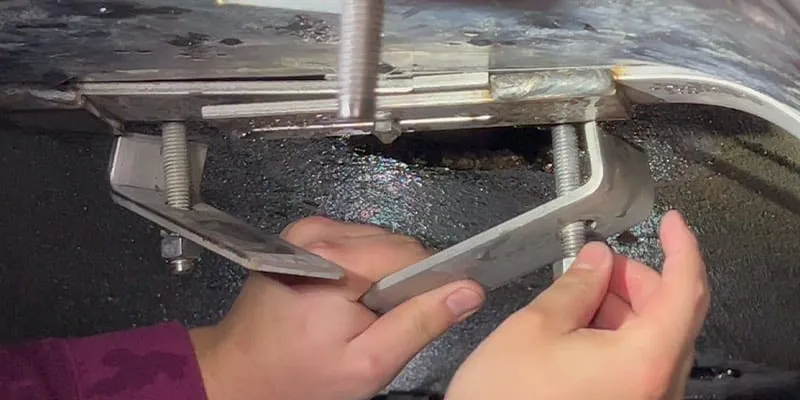 Adjusting the hold-downs for this HydarTite installation over a joint in a box-shaped culvert