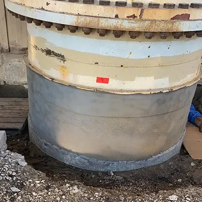 A portion of a riser that has had its surface ground clean